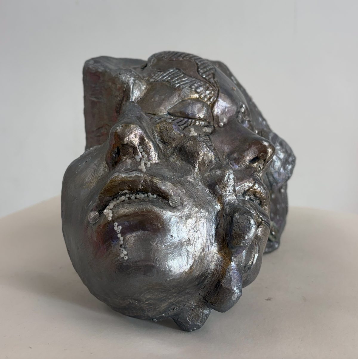 Head with Shells and Pearls, left